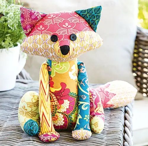 Colorful fabrics make this fox sewing pattern a MUST make! Perfect for a child's toy or a sweet gift to sit on the bed.