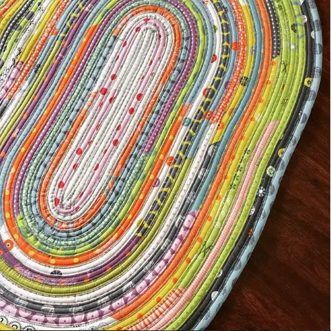 Turn your jelly roll pieces into a one of a kind spiral accent rug for your space. They are easy to make and perfect for beginners.
