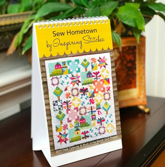 Check out Sew Hometown from Inspiring Stitches. Not only is this pattern design beyond cute but it's also a quilt calendar for your desk. 