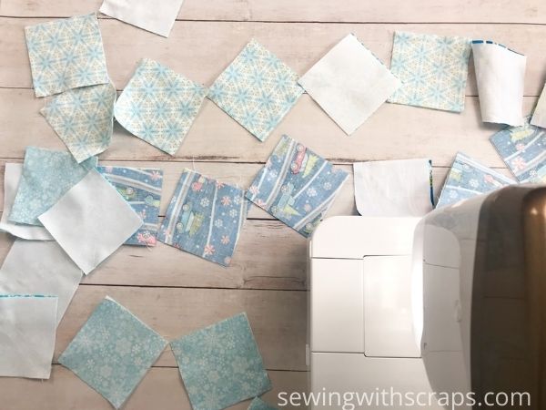 Chain piecing the Pinwheel Present quilt block.