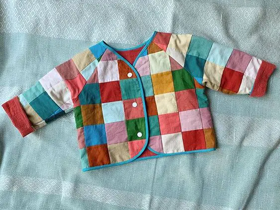 Patchwork baby jacket using the Lullaby Layette pattern by Oliver + S.